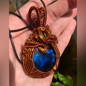 Wire wrapped Dark Blue Labradorite crystal.